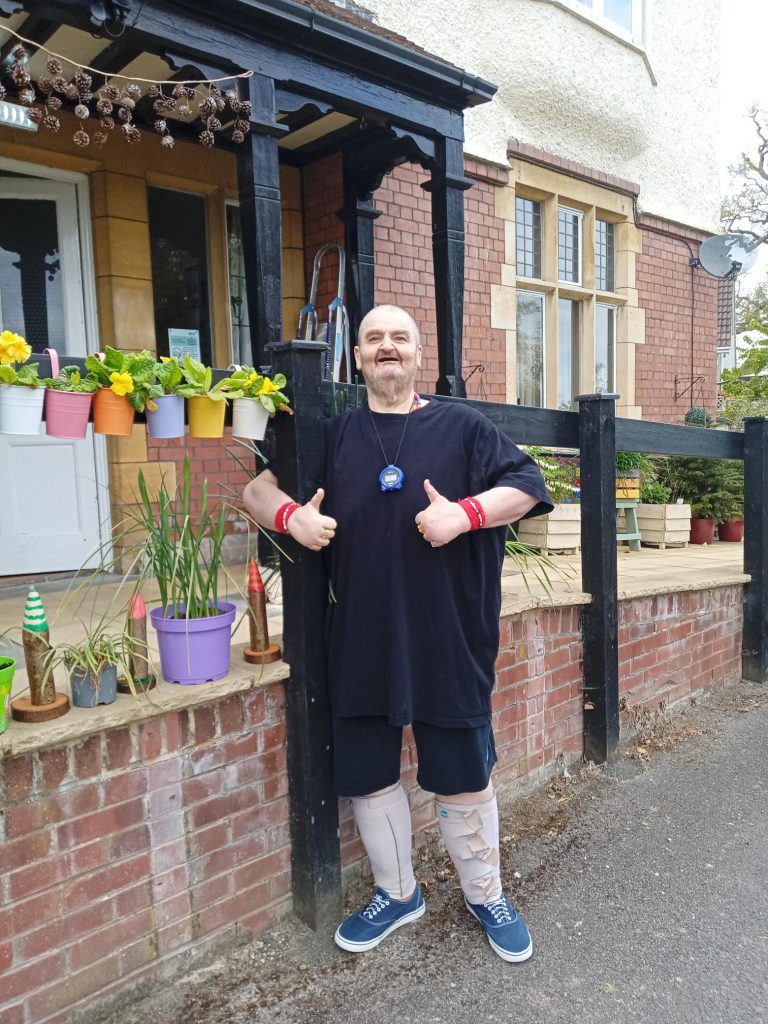 David can be seen smiling outside Cote House Residential Nursing Care home after a successful long distance walk.

