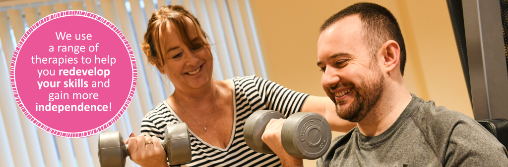 A person we support in the gym with their support worker. Both are holding a dumbbell. A circular, pink text box says "We use a range of therapies to help you redevelop your skills and gain more independence". 